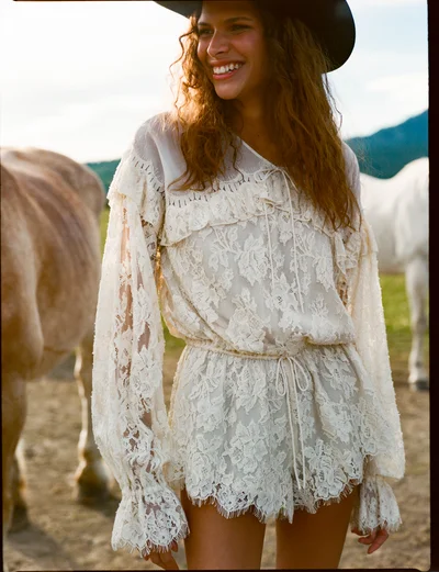Photo of Country Rose Lace Romper in Ivory on model, view 1