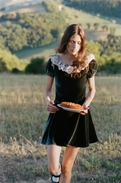 Photo of La Vie En Bow Velvet Boatneck Mini Dress in Green on model, view 1
